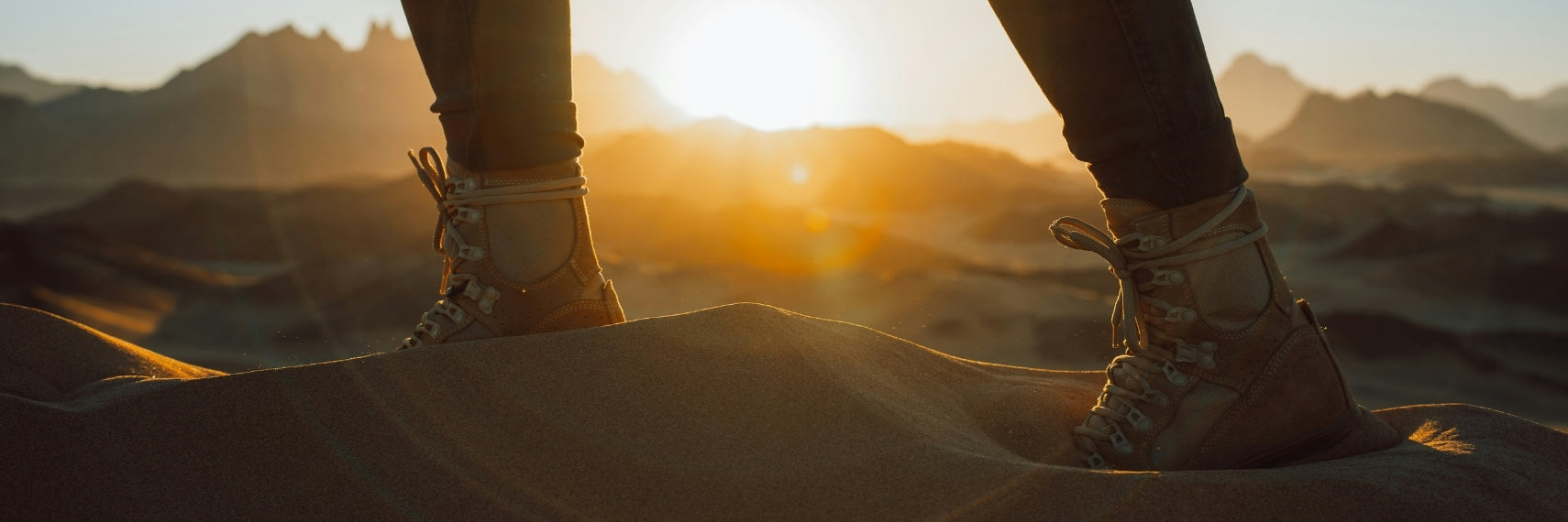 person walking on sand in the desert