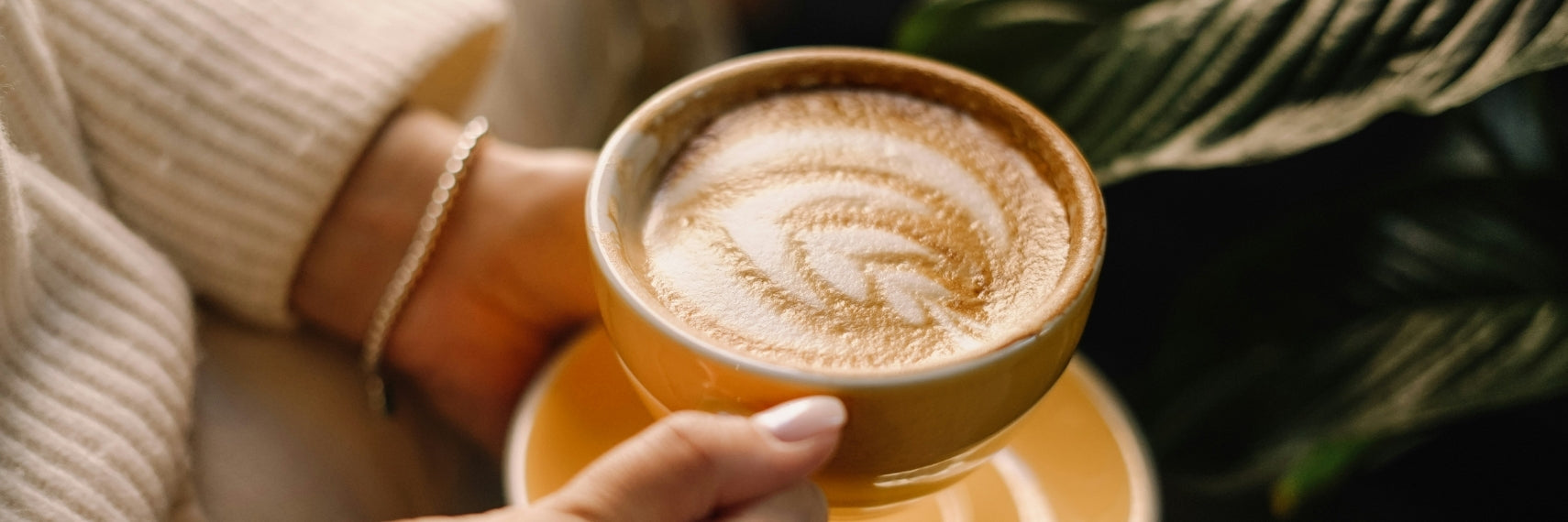 woman holding coffee with creamer