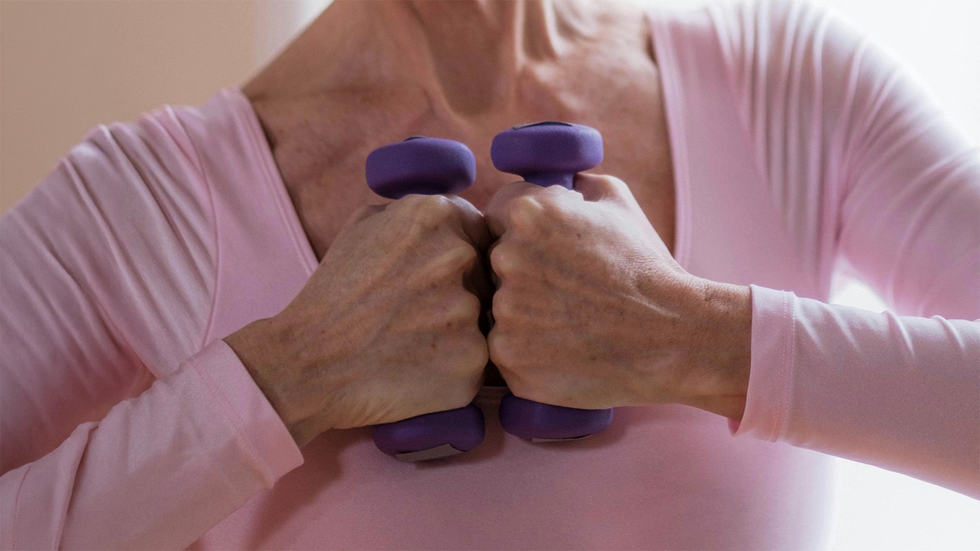 Middle-aged woman holding dumbbells