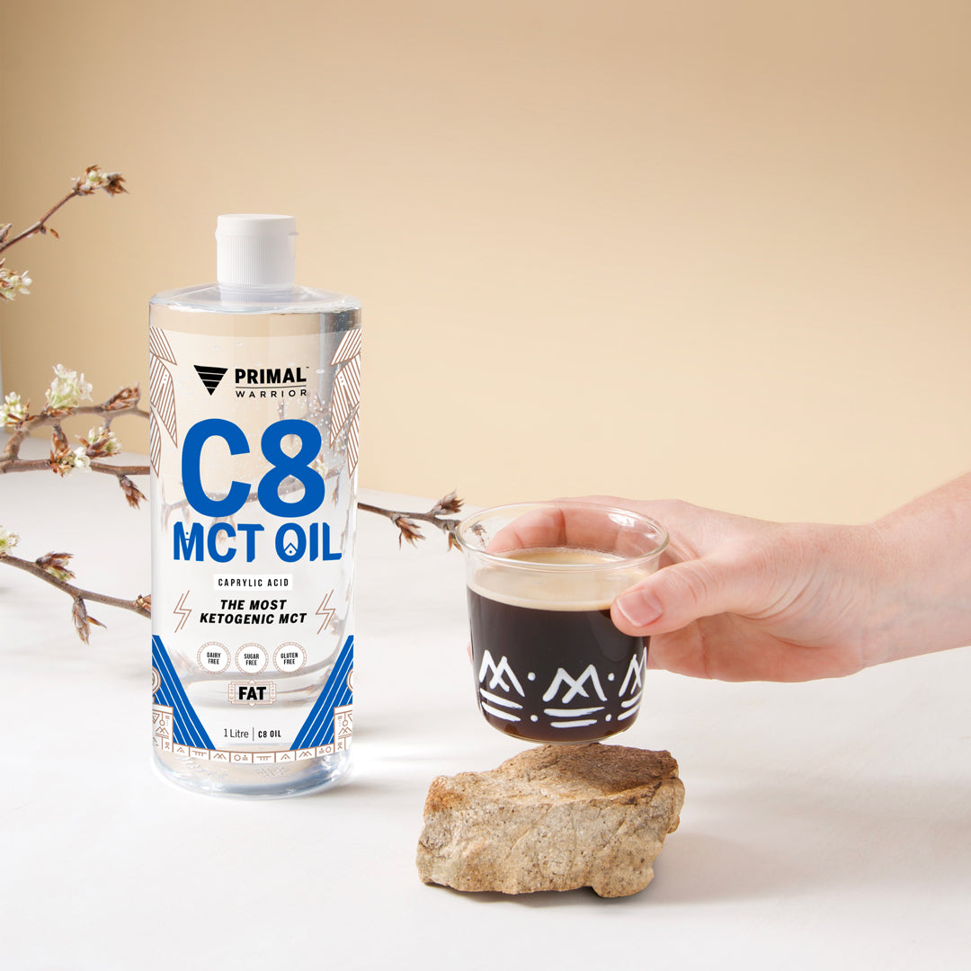 Primal Warrior C8 MCT Oil shown mixed with black coffee, as a natural keto dietary fat to add to your daily drinks.